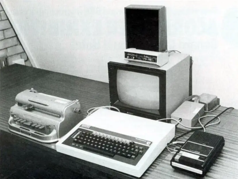 Black-and-white photograph of the 1983 Vincent Work Station, showing a Perkins Brailler connected to a BBC Micro computer, monitor and cassette equipment.